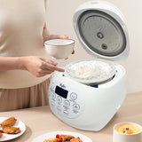 Person using a white rice cooker with food on a table